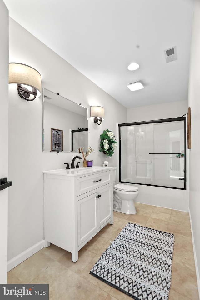 full bathroom featuring bath / shower combo with glass door, toilet, tile patterned floors, and vanity