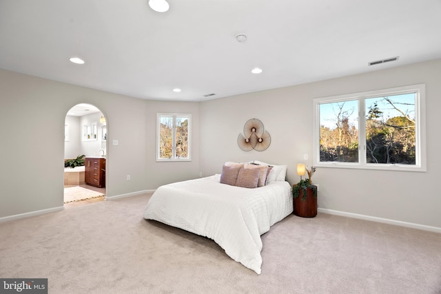 carpeted bedroom with ensuite bathroom