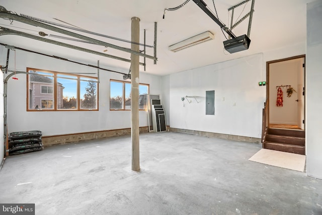 garage with electric panel and a garage door opener