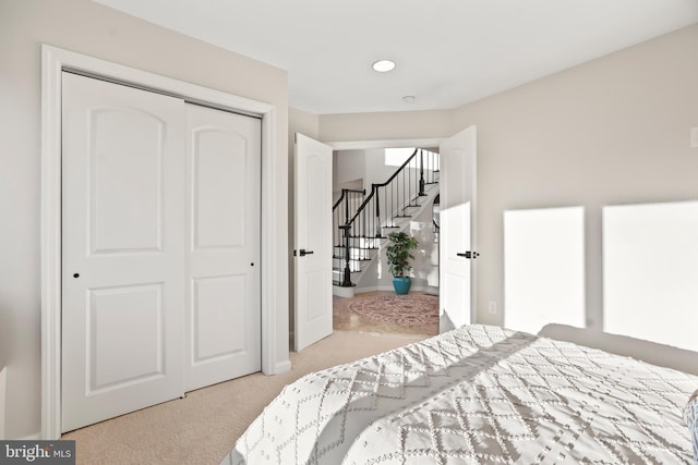 carpeted bedroom featuring a closet