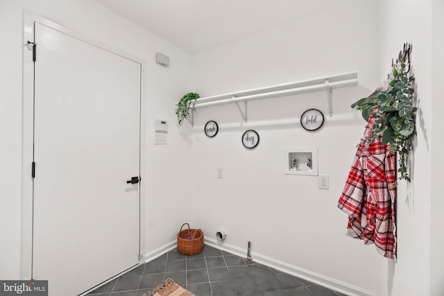 clothes washing area featuring gas dryer hookup, hookup for a washing machine, and dark tile patterned flooring