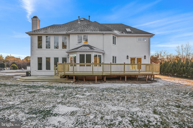 rear view of house featuring a deck and a patio