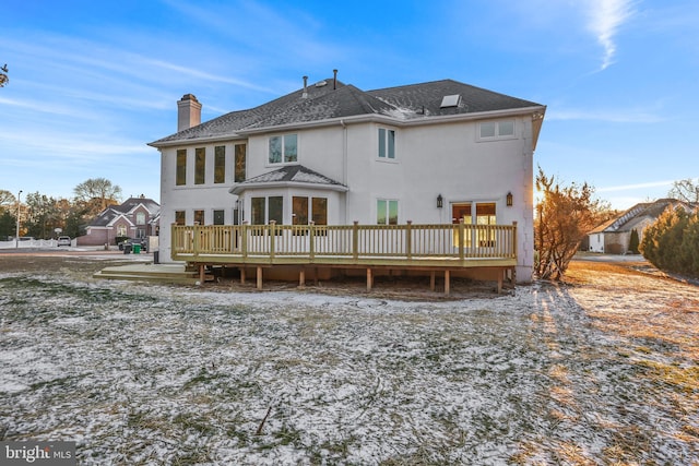 back of house featuring a wooden deck