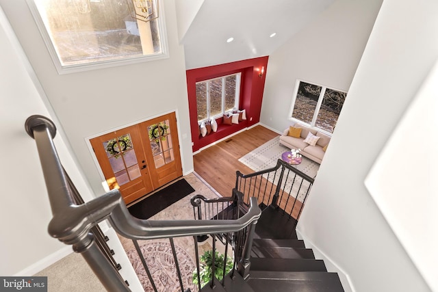 entryway with a towering ceiling and french doors