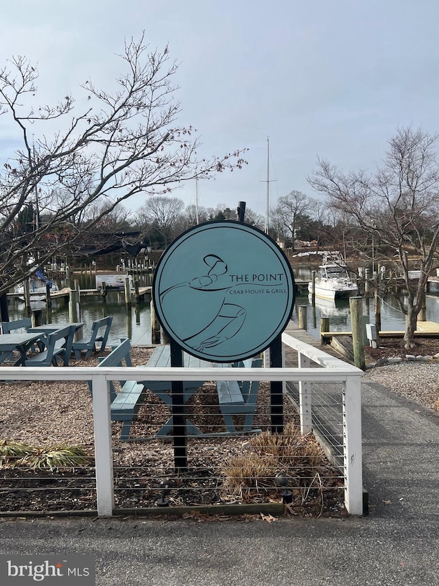 exterior space featuring a water view and a dock