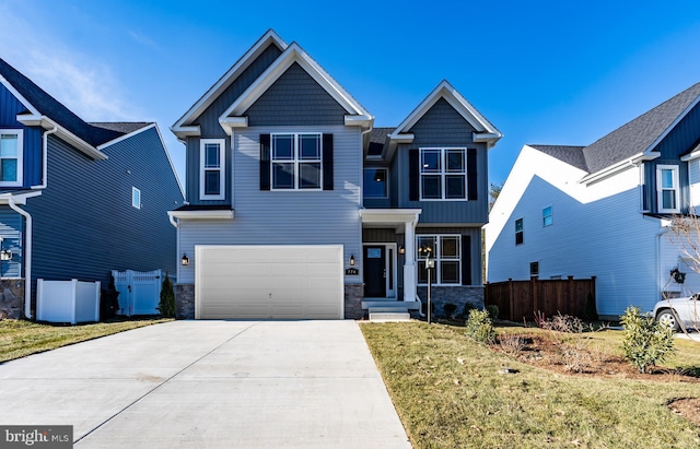 craftsman-style home with a garage and a front lawn