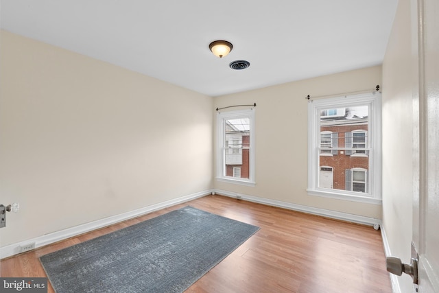 unfurnished room with light hardwood / wood-style flooring