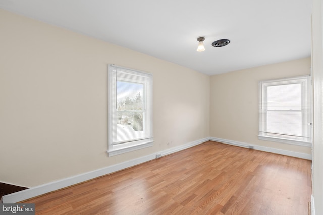 spare room with light hardwood / wood-style flooring