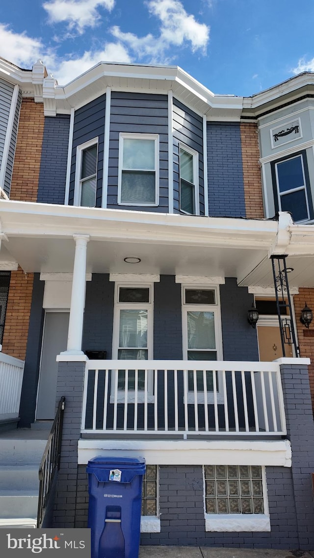 view of property exterior with a balcony and a porch