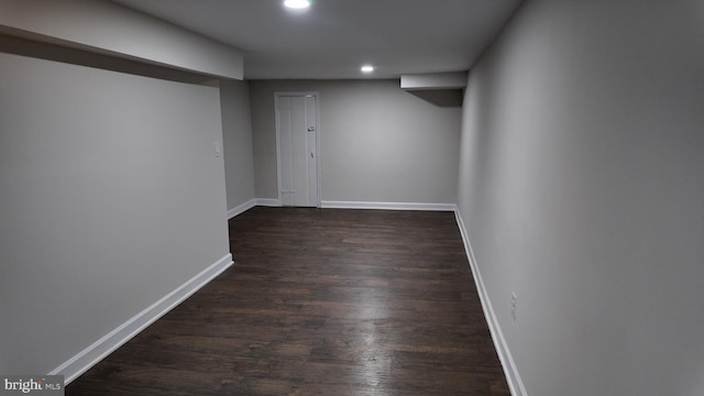 basement with dark hardwood / wood-style flooring