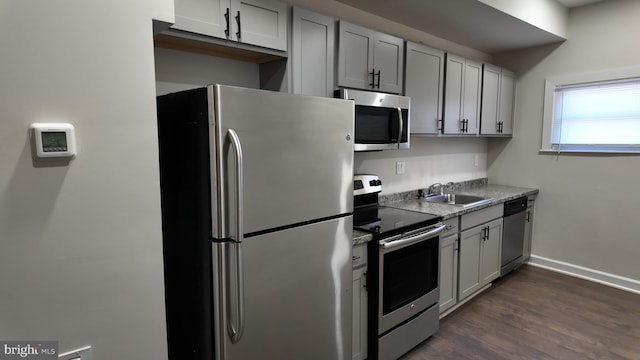 kitchen featuring appliances with stainless steel finishes, sink, and dark hardwood / wood-style floors