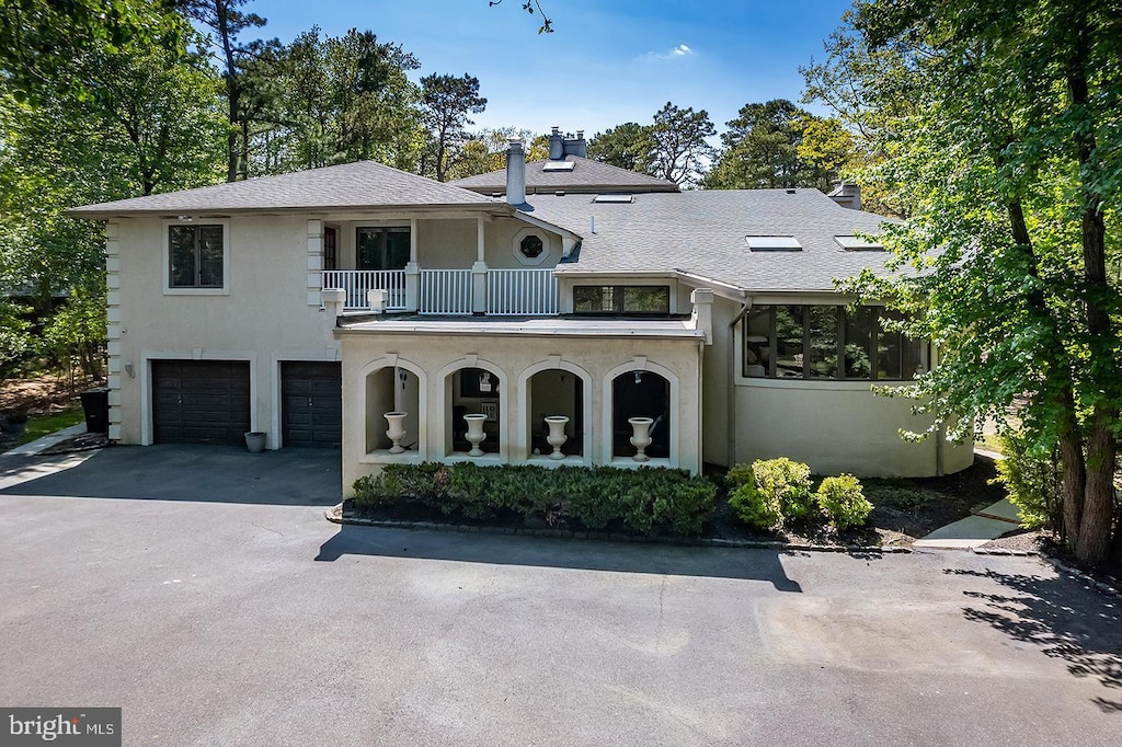 view of front of house with a balcony and a garage