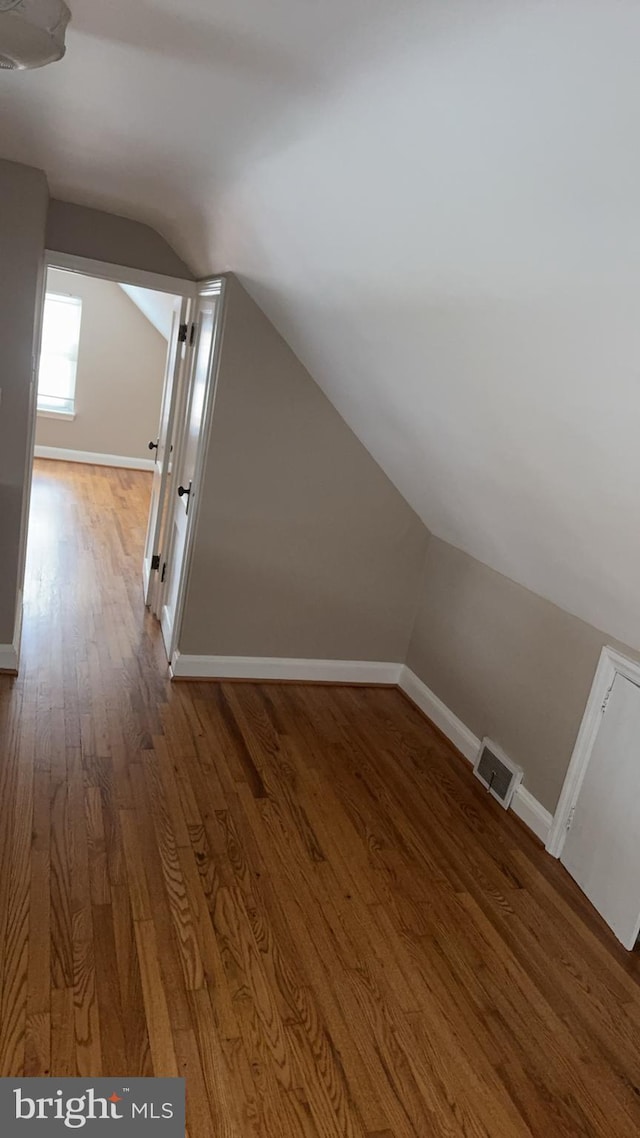 bonus room featuring hardwood / wood-style flooring and vaulted ceiling