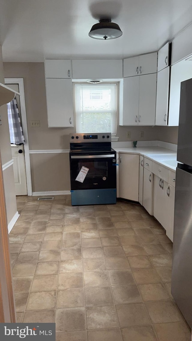 kitchen featuring stainless steel appliances and white cabinets