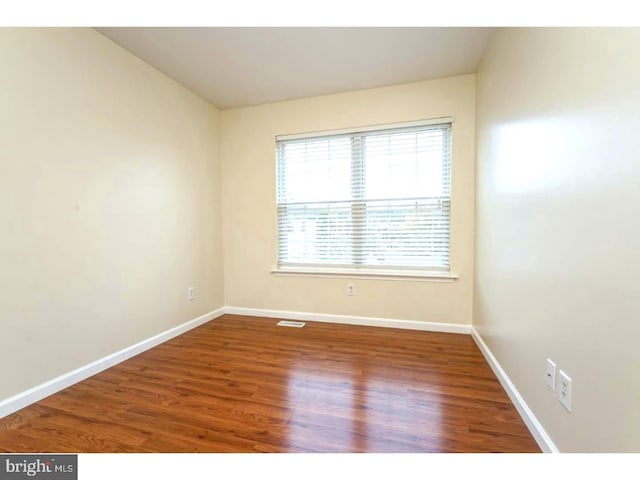 unfurnished room featuring hardwood / wood-style flooring