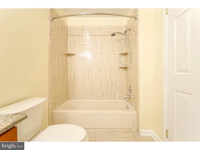 full bathroom with tiled shower / bath, tile patterned floors, toilet, and vanity