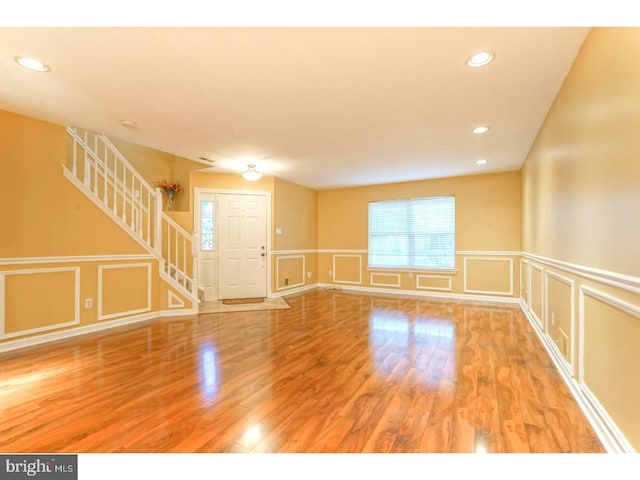 empty room with hardwood / wood-style flooring