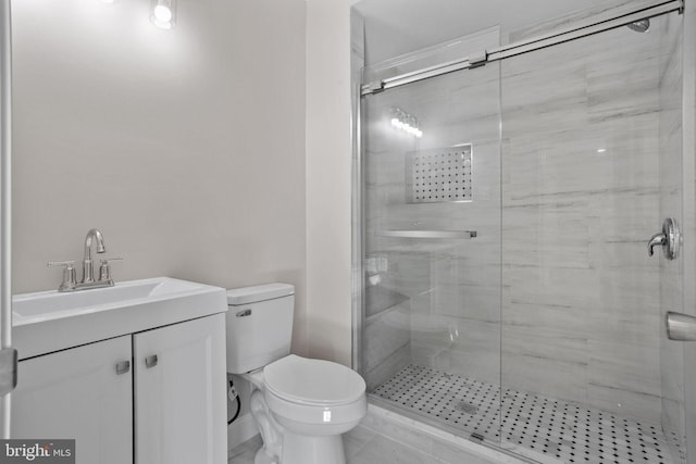 bathroom featuring vanity, walk in shower, and toilet