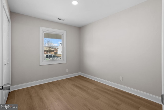 unfurnished bedroom featuring a closet and light wood-type flooring