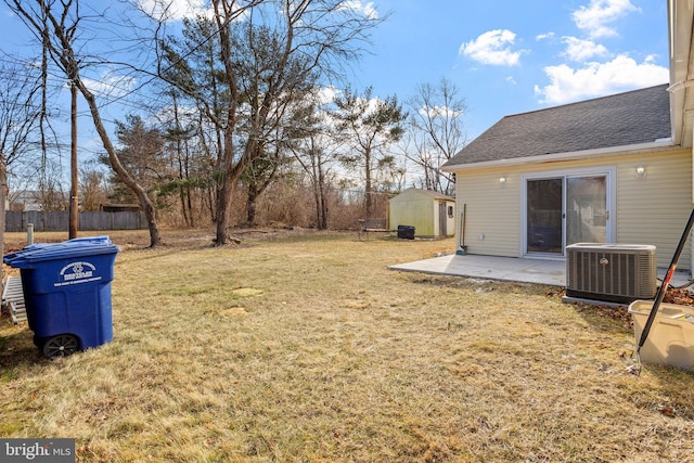 view of yard featuring a patio, central AC unit, and a storage unit