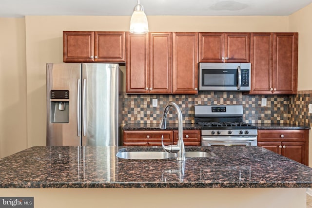 kitchen with sink, backsplash, stainless steel appliances, and dark stone countertops