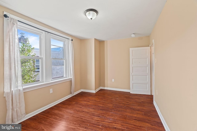 spare room with dark hardwood / wood-style flooring