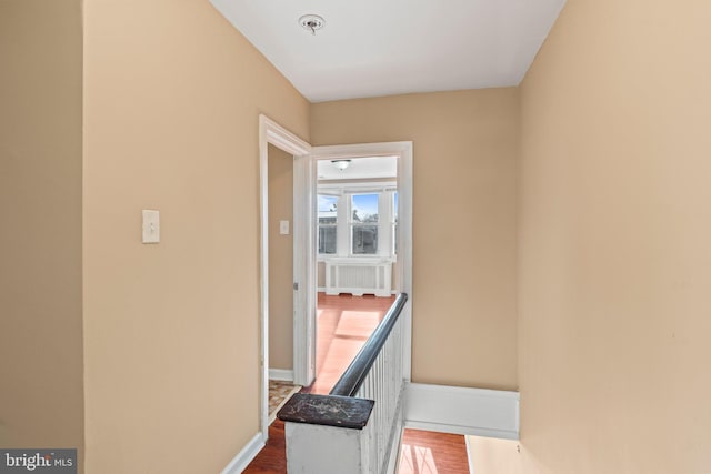 corridor with hardwood / wood-style flooring