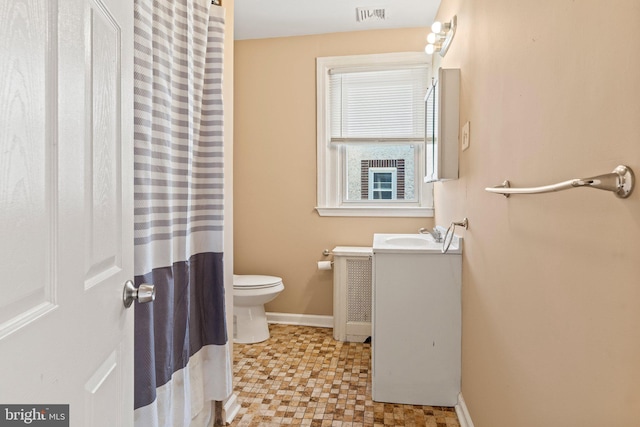 bathroom featuring toilet and vanity