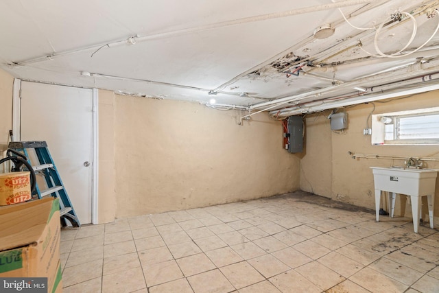 basement featuring sink and electric panel