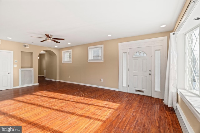 foyer with ceiling fan, a wealth of natural light, and wood-type flooring