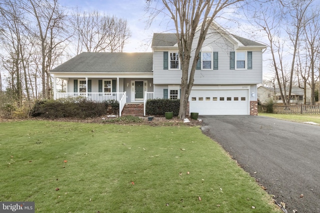 split level home featuring a garage, covered porch, and a front lawn