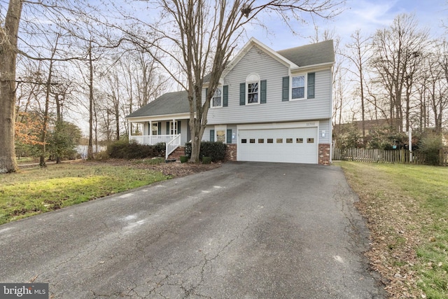 view of front facade with a porch, a garage, and a front lawn