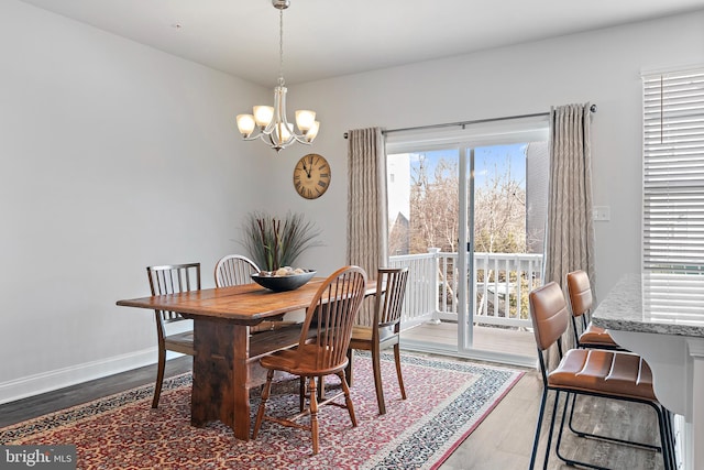 dining space with an inviting chandelier and dark hardwood / wood-style floors