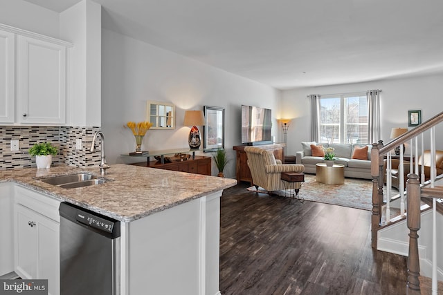 kitchen featuring dishwasher, light stone countertops, sink, and white cabinets