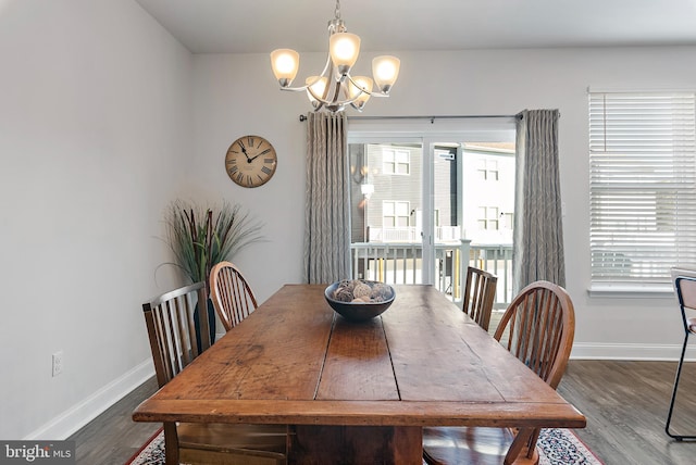 dining space featuring a notable chandelier and dark hardwood / wood-style flooring