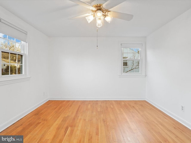 empty room with ceiling fan and light wood-type flooring