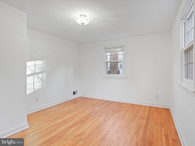 spare room with light wood-type flooring