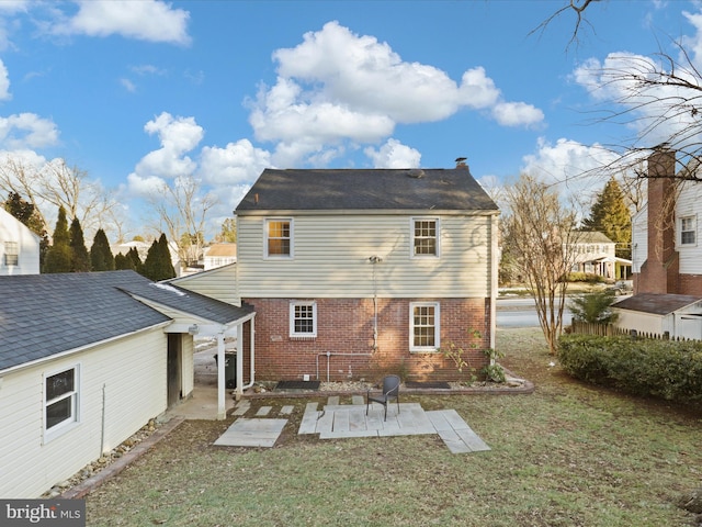 back of house with a lawn and a patio area