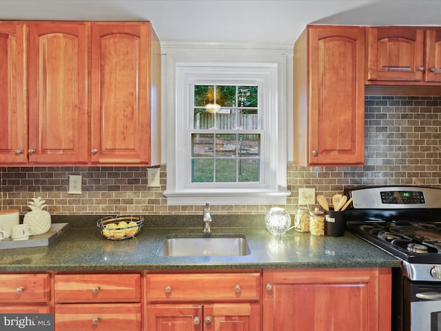 kitchen featuring sink, gas stove, and backsplash