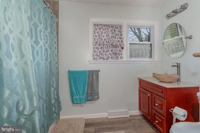 bathroom with a shower with curtain, vanity, and hardwood / wood-style floors