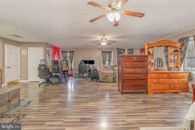 interior space with light hardwood / wood-style floors and ceiling fan