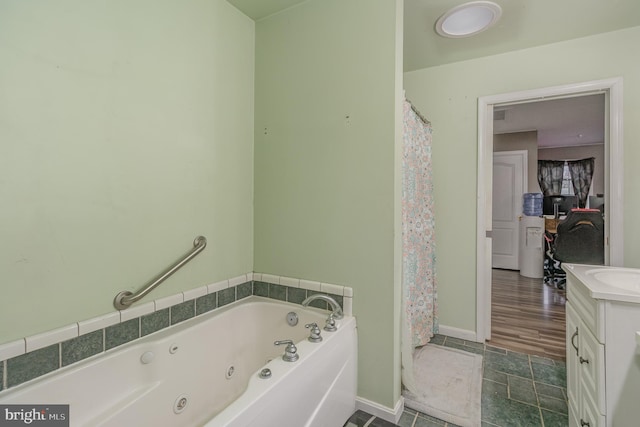 bathroom with vanity and a tub to relax in