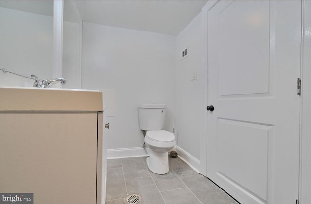 bathroom featuring vanity, toilet, and tile patterned floors