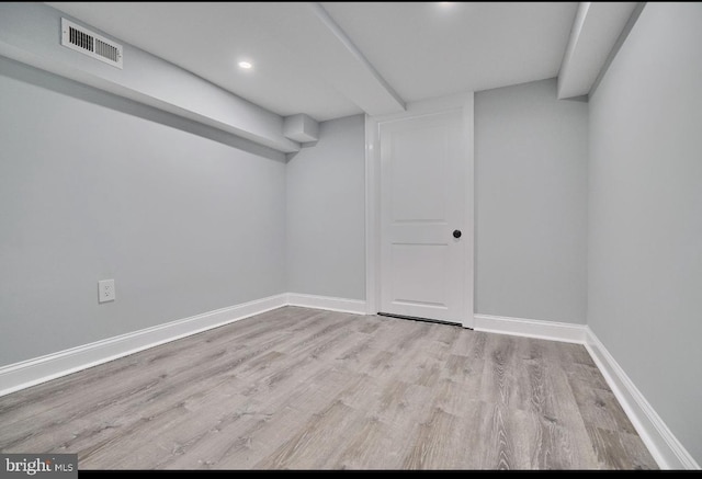 basement with light hardwood / wood-style flooring