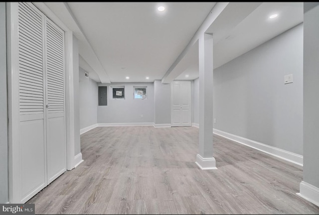 basement with light hardwood / wood-style floors