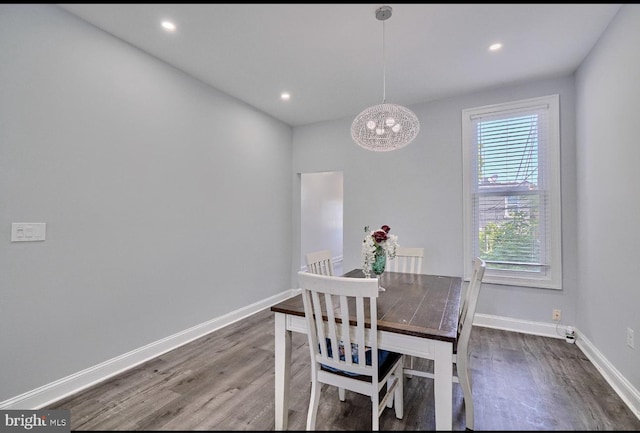 dining room featuring a notable chandelier and dark wood-type flooring