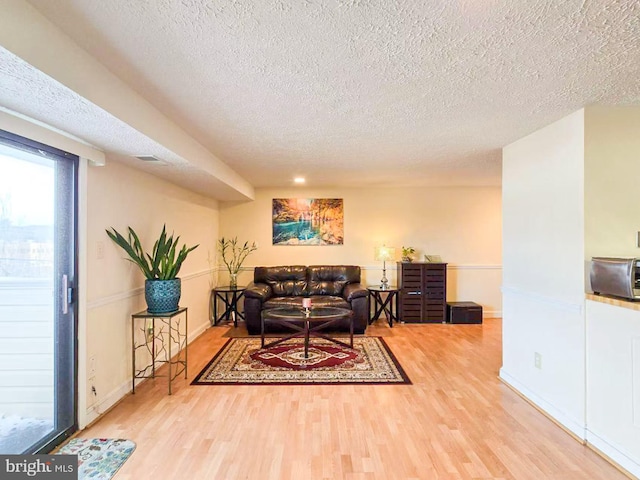 living room featuring hardwood / wood-style flooring and a textured ceiling