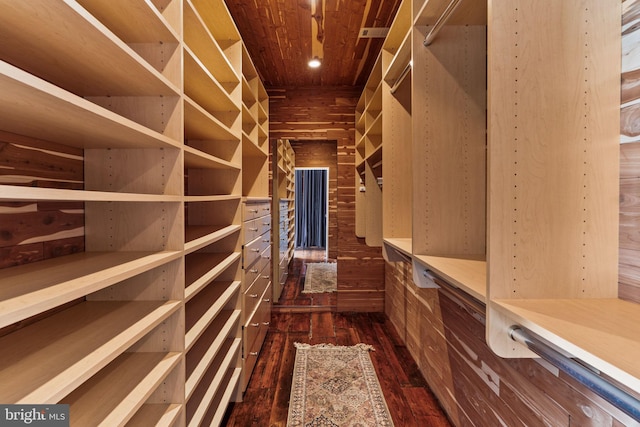 walk in closet with dark wood-type flooring