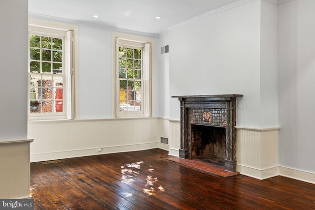 unfurnished living room featuring crown molding and wood-type flooring