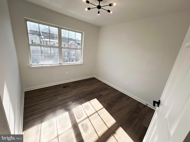 unfurnished room with dark wood-type flooring